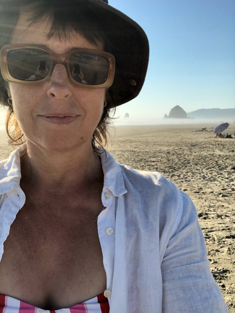 Photo of author at the beach wearing a hat